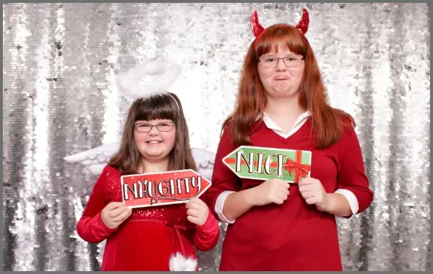 Group with Santa hats at holiday photo booth
