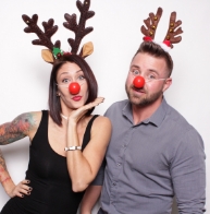 Family posing with holiday themed props and decorations