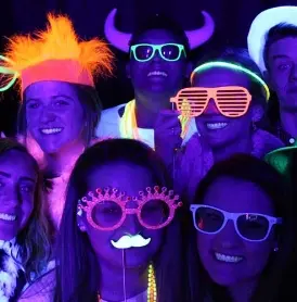 Guests glowing under UV blacklight photo booth