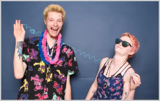 Friends having fun at a birthday party photo booth