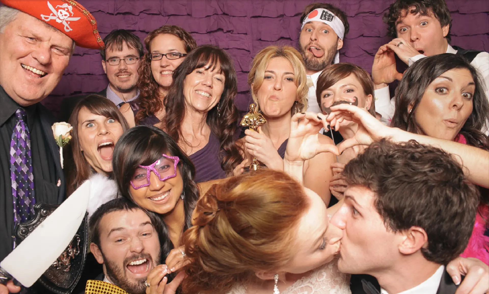 Wedding party celebrating under purple uplighting